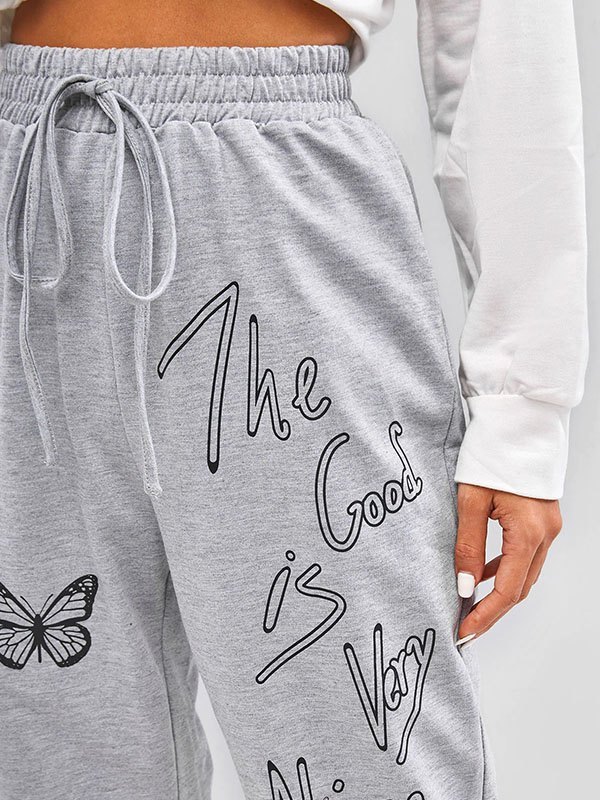 EMMIOL Pantalones joggers con estampado de mariposas y eslogan