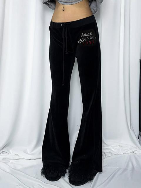 Pantaloni a zampa con strass e lettere